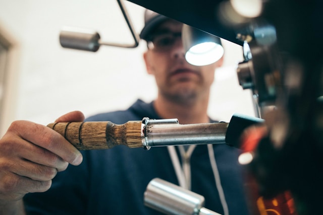 Man in black hoodie holding tool